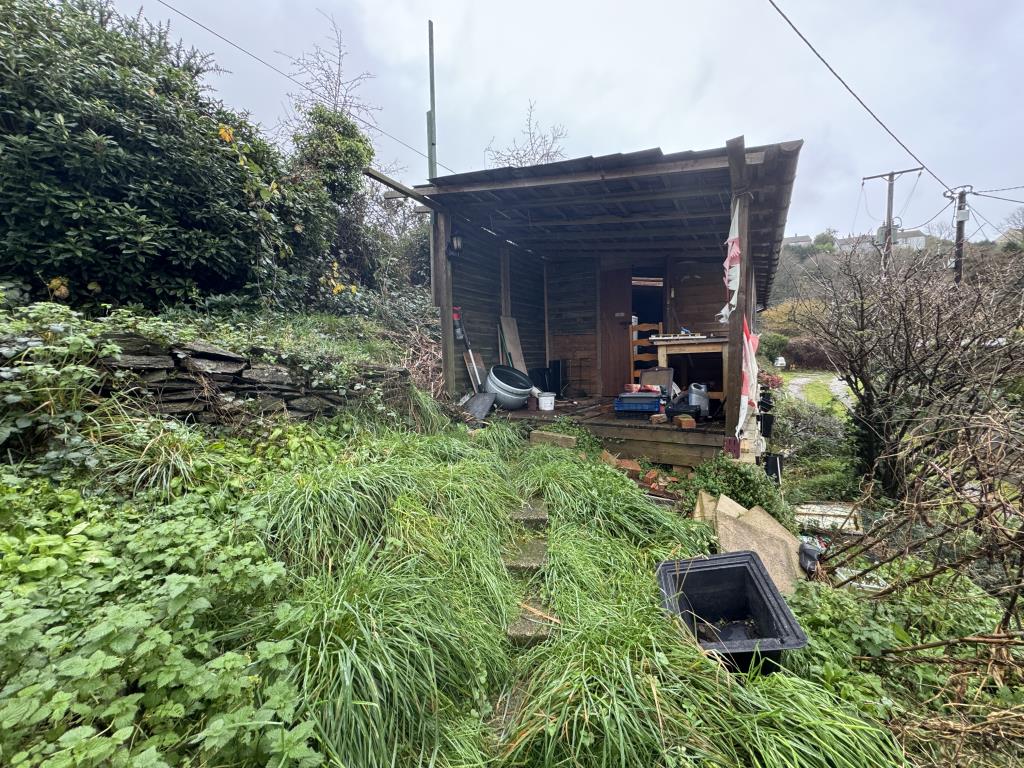 Lot: 51 - SEMI-DETACHED BUNGALOW FOR IMPROVEMENT - View of timber outbuilding